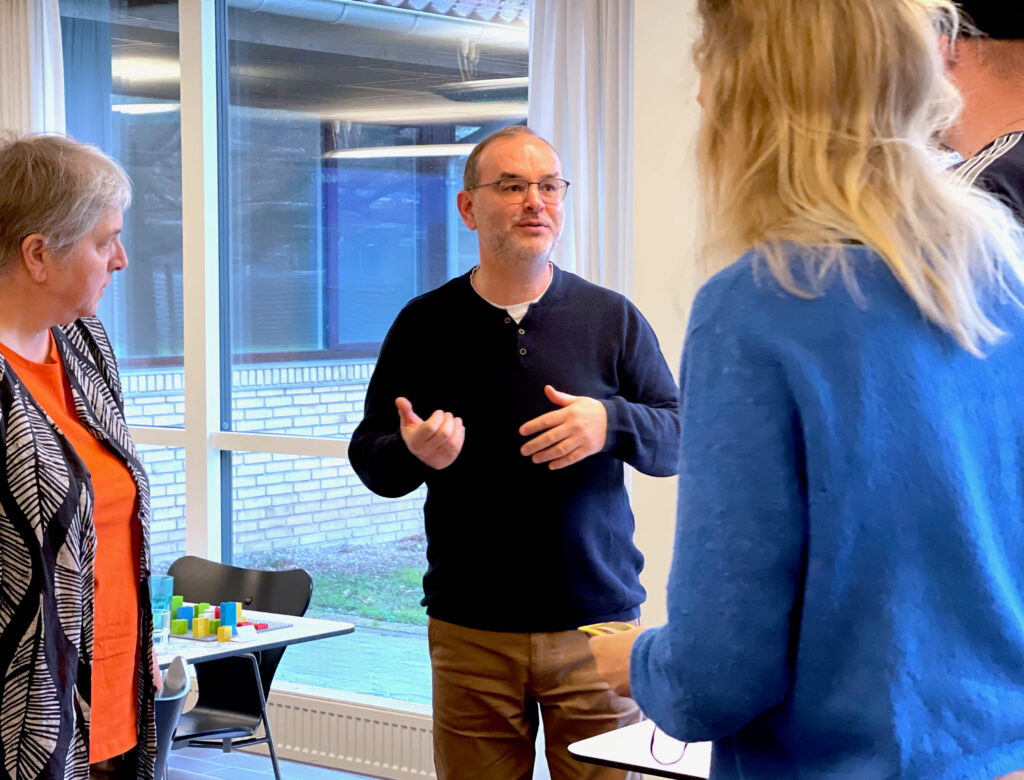 Den ene underviser taler med deltagere